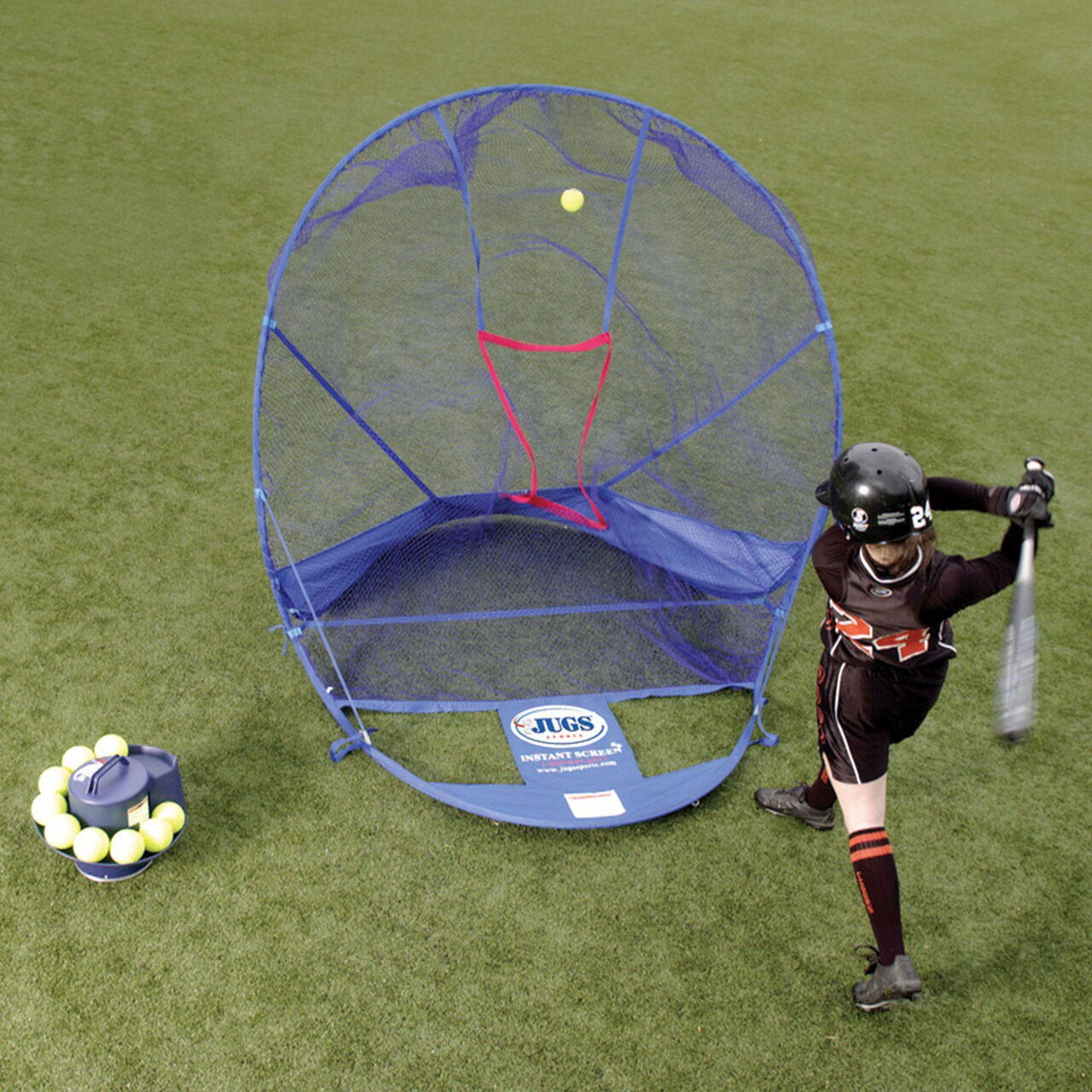 player hitting balls into a net outside