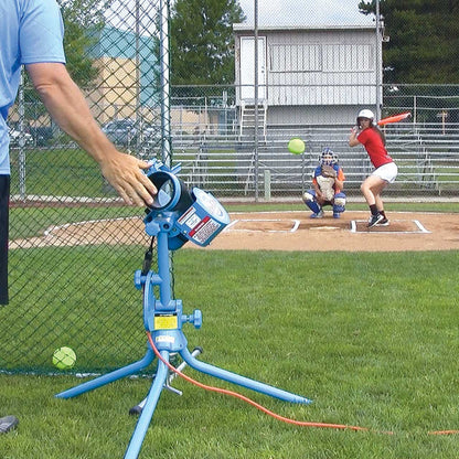 Coach using JUGS Lite-Flite® Pitching Machine to throw softballs to a female batter