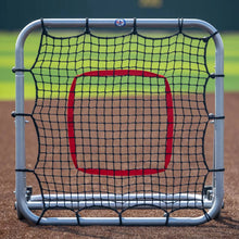 Large rebounder with silver frame and red target on field front the front