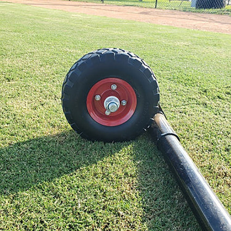 inside of red screen wheel on the end of a tube sitting on grass