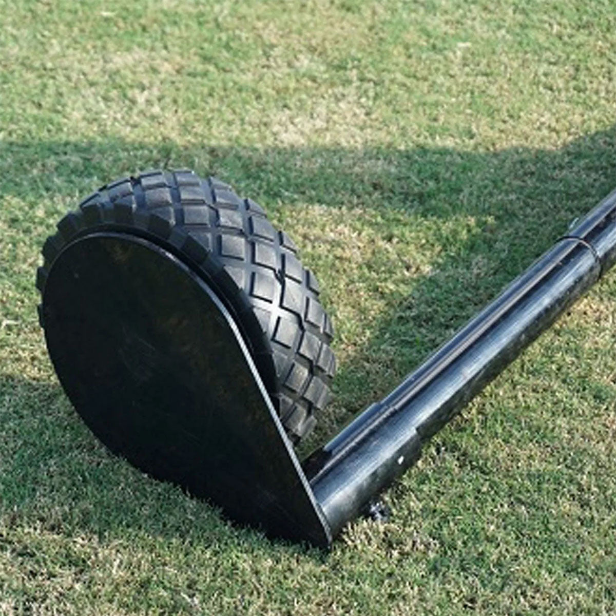 screen wheel on the end of a tube sitting on grass