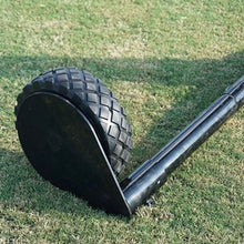 screen wheel on the end of a tube sitting on grass